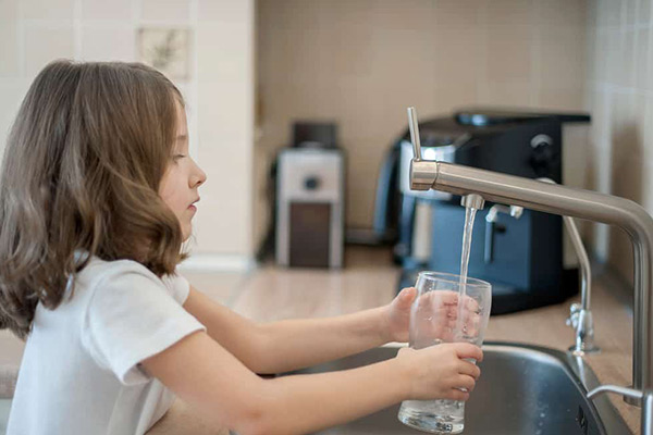 girl-filling-a-glass-of-water